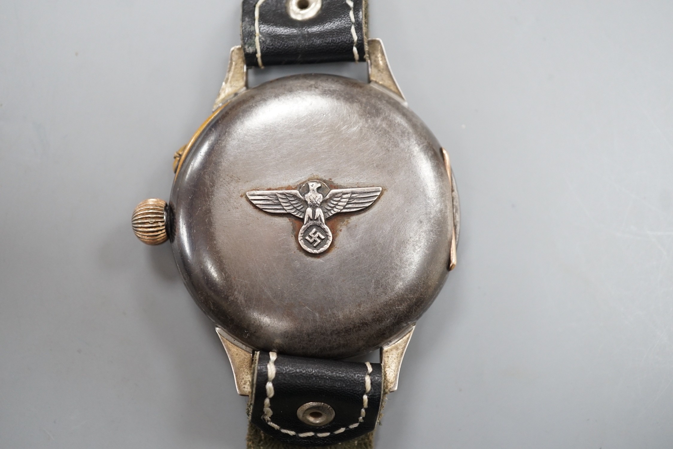 A Kriegsmarine style gun metal manual wind wrist watch, converted from a pocket watch, with later adapted dial, on a leather strap